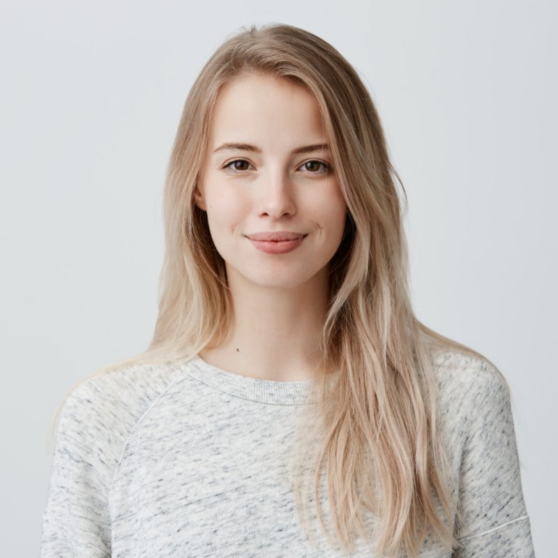 pretty-smiling-joyfully-female-with-fair-hair-dressed-casually-looking-with-satisfaction